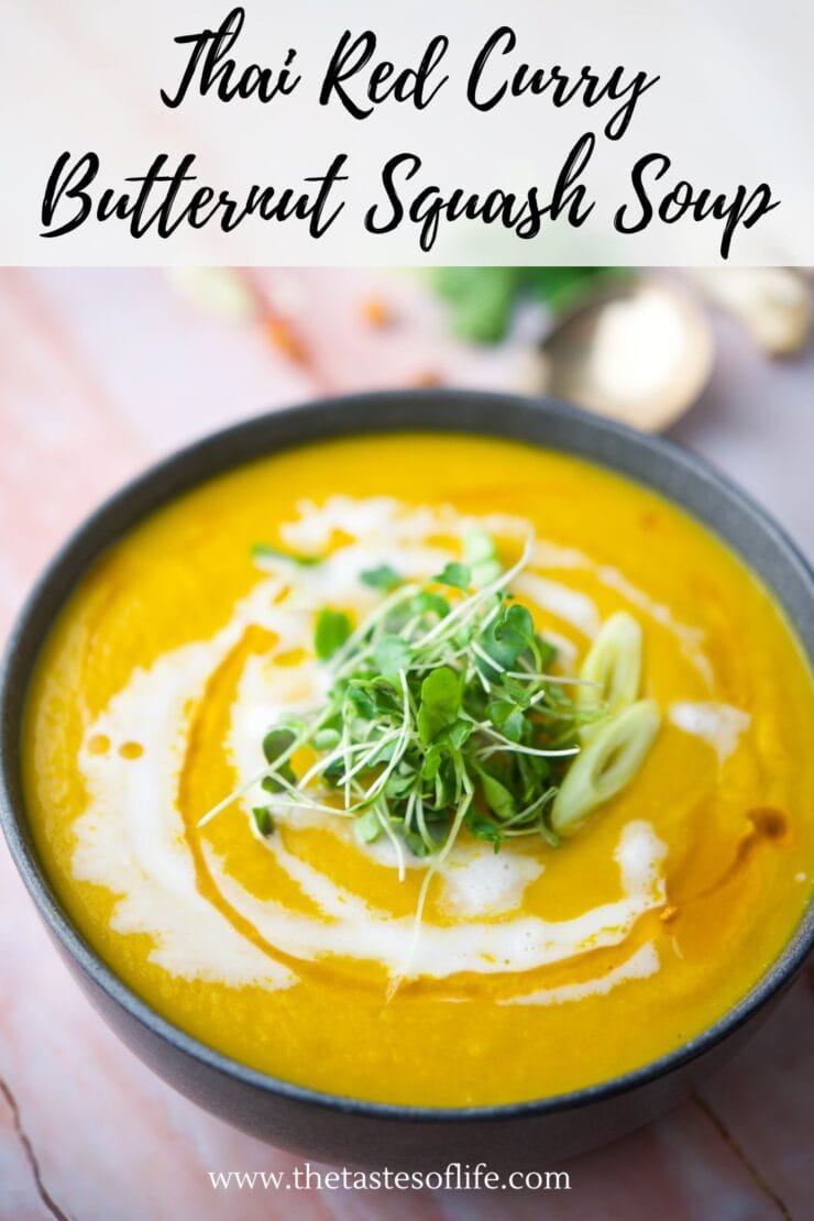 A bowl of Thai red curry butternut squash soup garnished with a swirl of cream, microgreens, and sliced green onions, with text overlay reading Thai Red Curry Butternut Squash Soup.