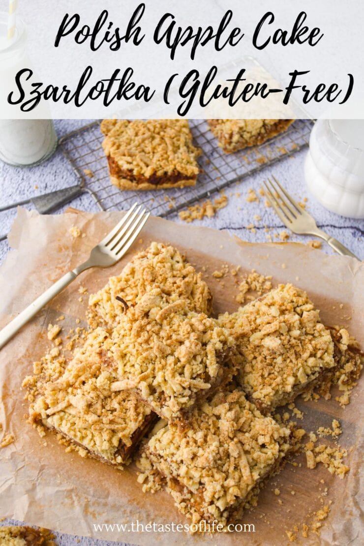 Gluten-free Polish apple cake (szarlotka) cut into squares, topped with crumble, displayed on parchment paper with forks nearby and glasses of milk in the background.