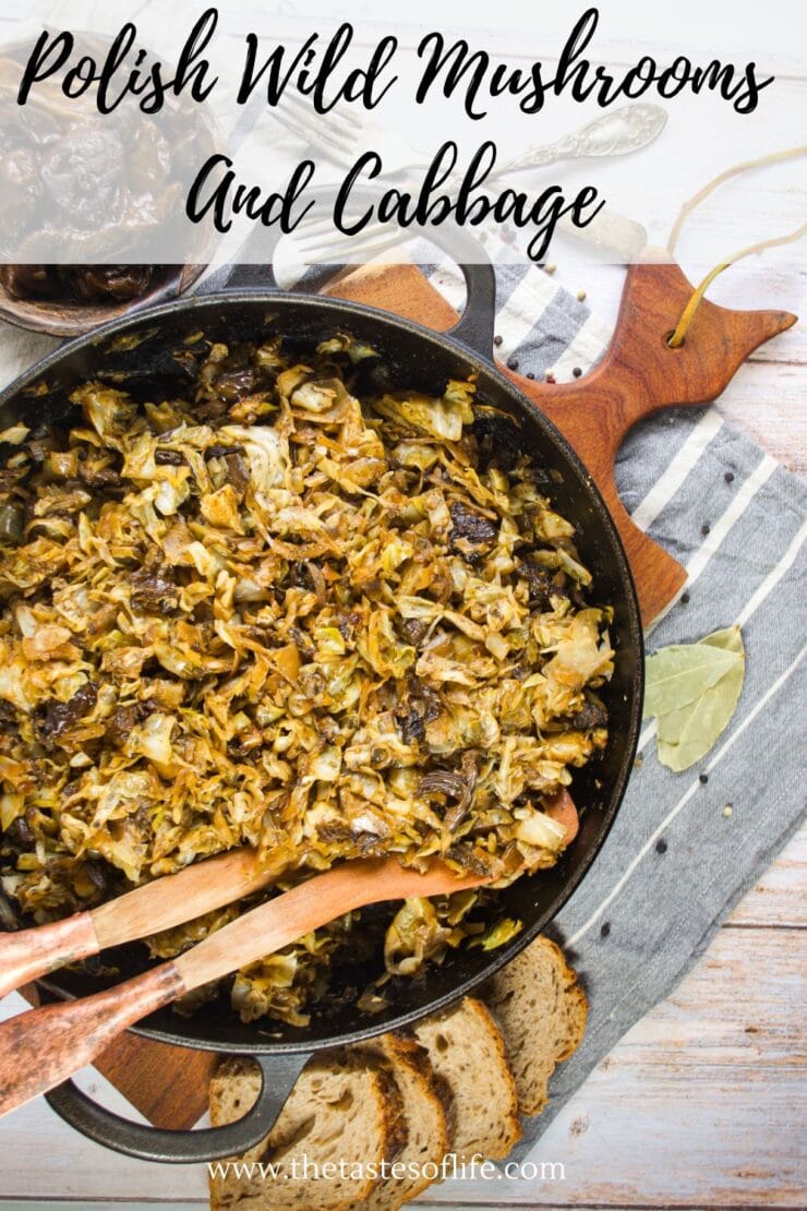 A skillet filled with saut&eacute;ed wild mushrooms and cabbage sits on a wooden cutting board. Slices of bread, a gray napkin, a bay leaf, and wooden utensils are nearby. Text on the image reads Polish Wild Mushrooms and Cabbage.