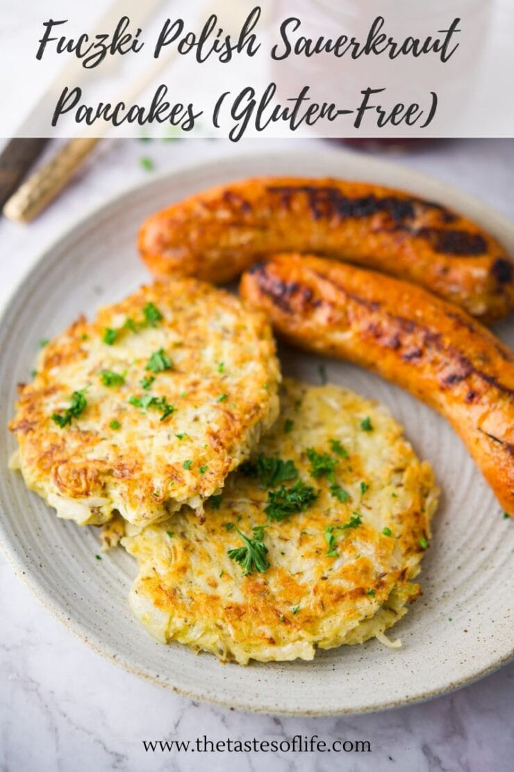 A plate with two golden-brown sauerkraut pancakes garnished with parsley, next to two grilled sausages. The text above reads &ldquo;Fuczki Polish Sauerkraut Pancakes (Gluten-Free).&rdquo;.