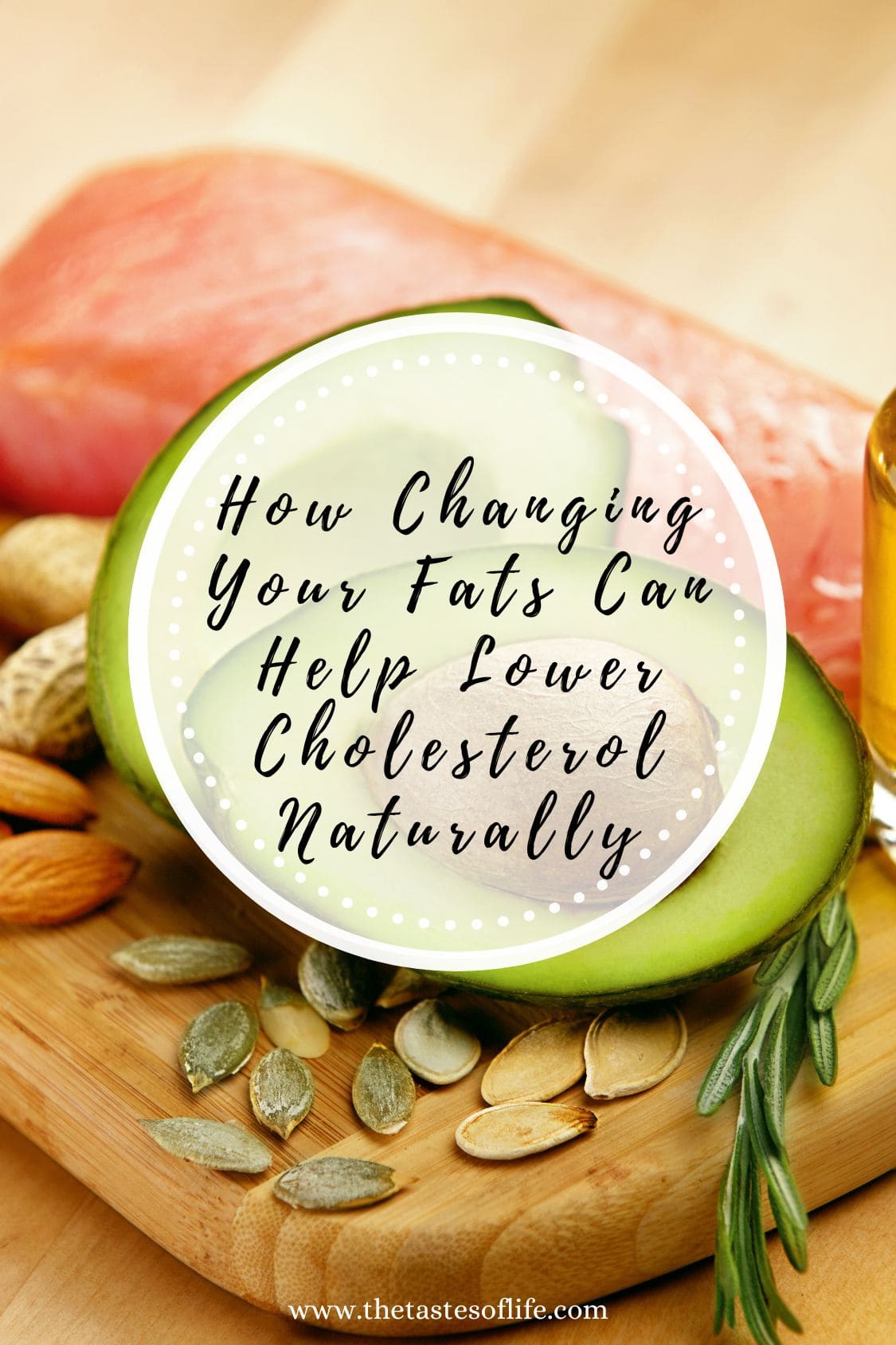 Halved avocado, nuts, seeds, raw salmon, and a bottle of oil on a wooden board with the text: How Changing Your Fats Can Help Lower Cholesterol Naturally for better heart health.