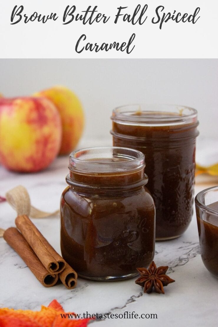 Two glass jars filled with brown butter fall spiced caramel, with cinnamon sticks and a star anise on the counter.