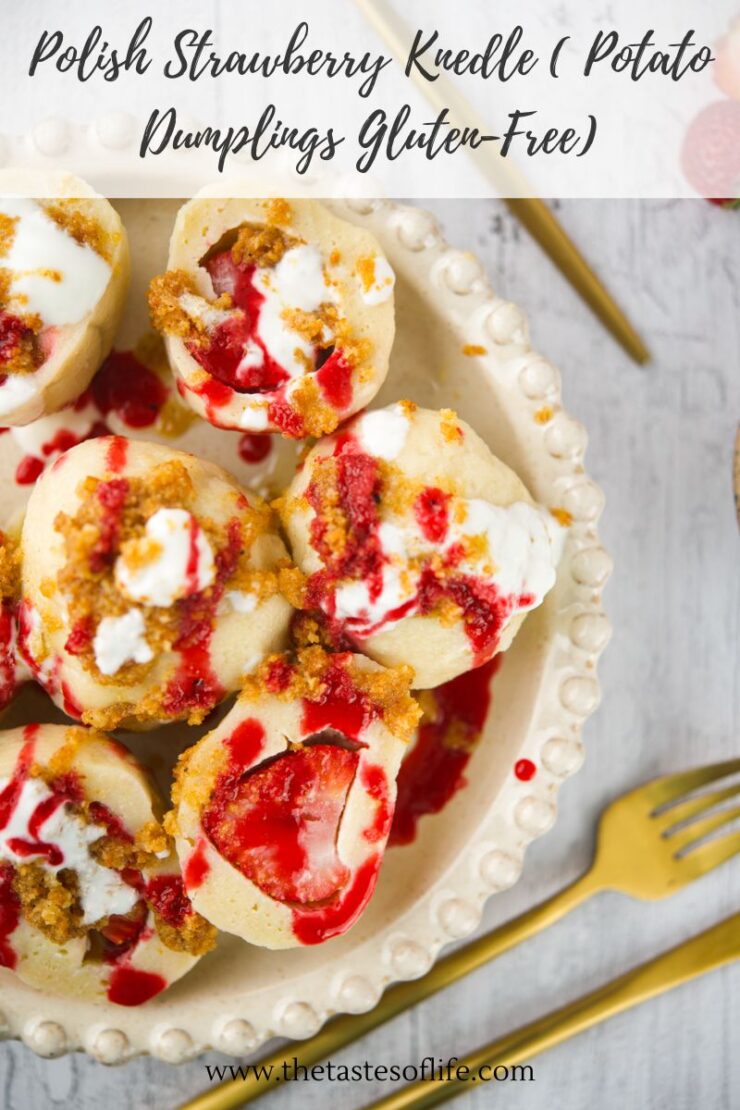 A plate of Polish strawberry knedle (potato dumplings) topped with white sauce and vibrant red strawberry sauce, served with a gold fork and knife on the side. Text above reads: Polish Strawberry Knedle (Potato Dumplings Gluten-Free).