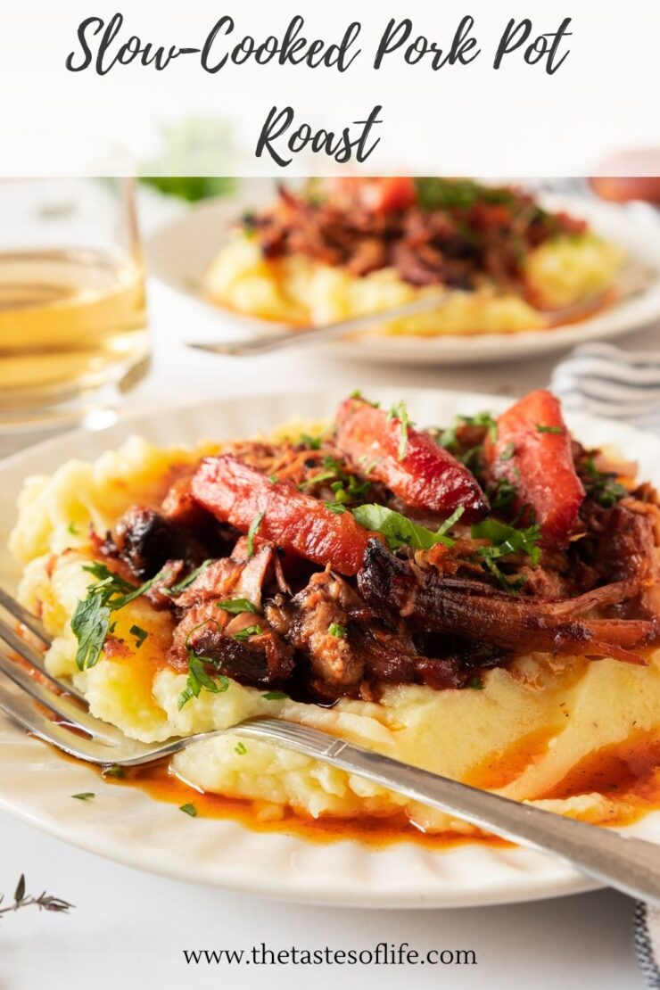 Slow-cooked pork roast with carrots served over a bed of mashed potatoes.