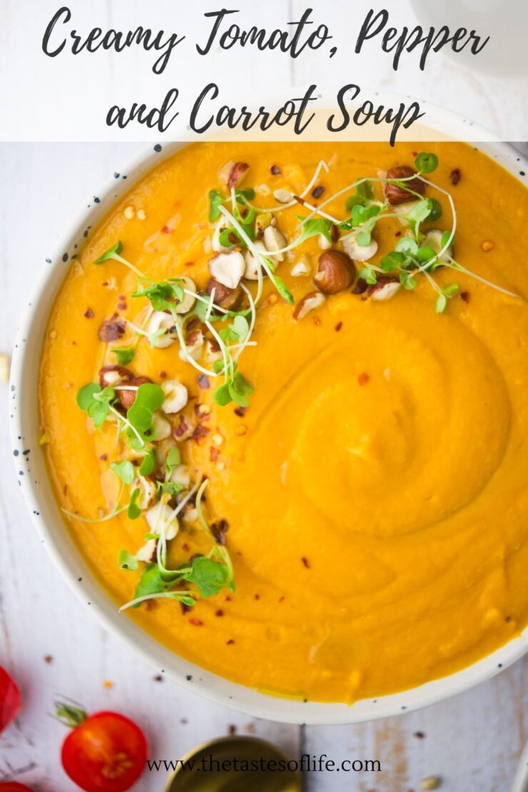 A bowl of creamy orange soup garnished with microgreens and chopped nuts sits on a white surface, with Creamy Tomato, Pepper and Carrot Soup written above. Cherry tomatoes are visible in the corner.