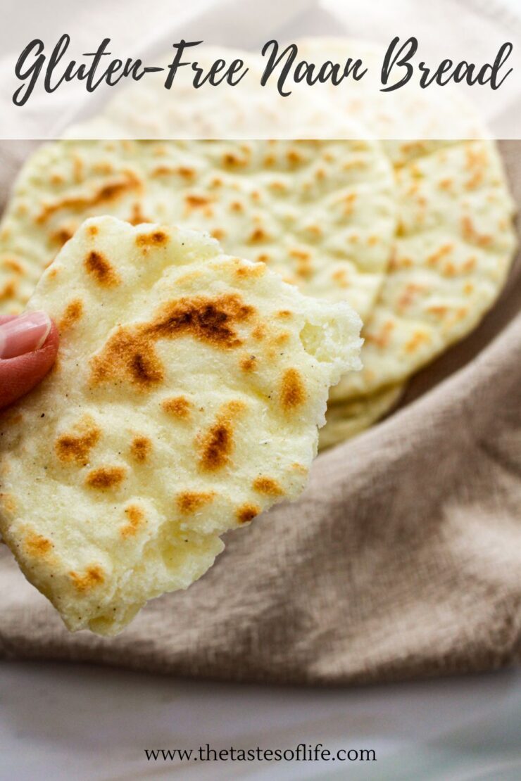 A hand holds a piece of gluten-free naan bread over a beige cloth with more naan pieces in the background. The text on the image reads, Gluten-Free Naan Bread and www.thetastesoflife.com.