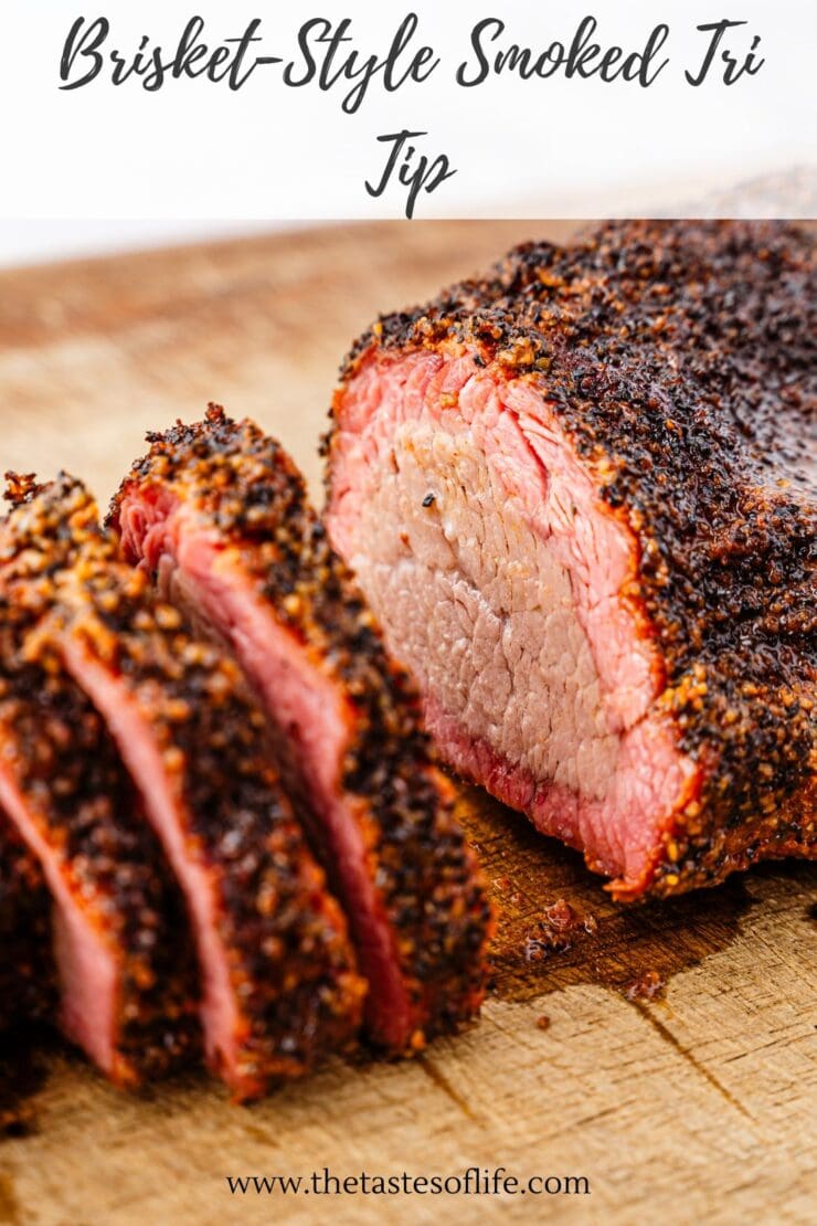 Close-up of a sliced, smoked tri-tip brisket on a wooden cutting board. The meat has a dark, seasoned crust and a juicy, pink interior. The words Brisket-Style Smoked Tri Tip appear at the top.
