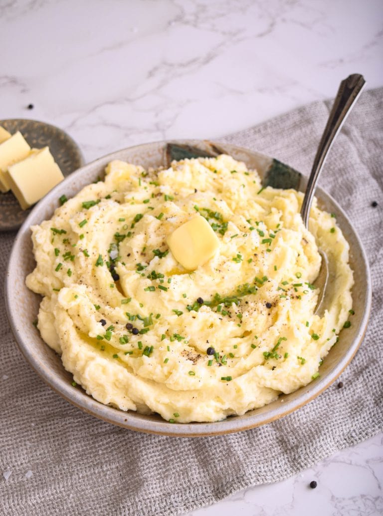 Mashed potatoes in a bowl with butter.