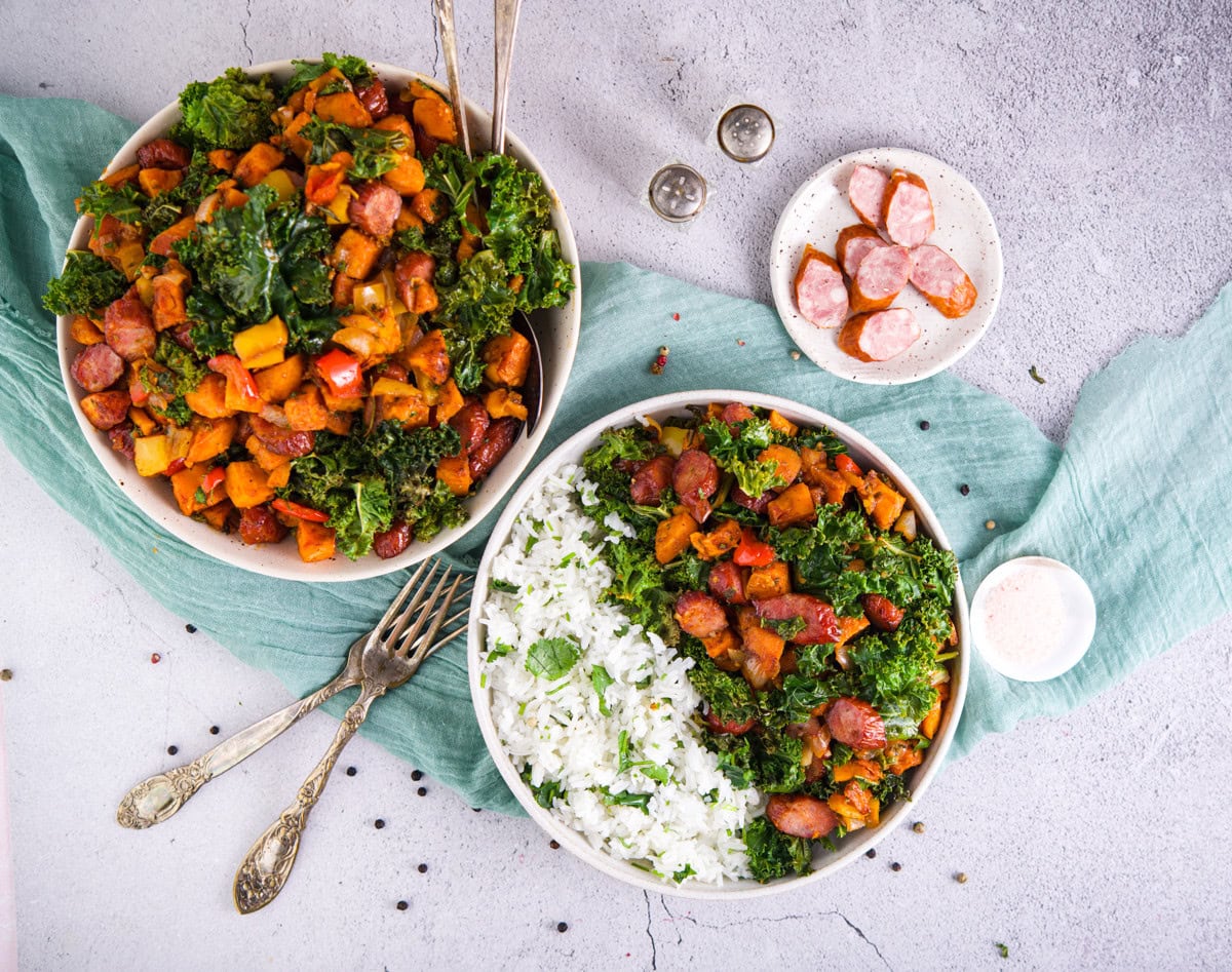 Vegan Buddha bowls with roasted sweet potatoes, kale, sausage, and fluffy rice. Healthy, colorful, and delicious plant-based meals.