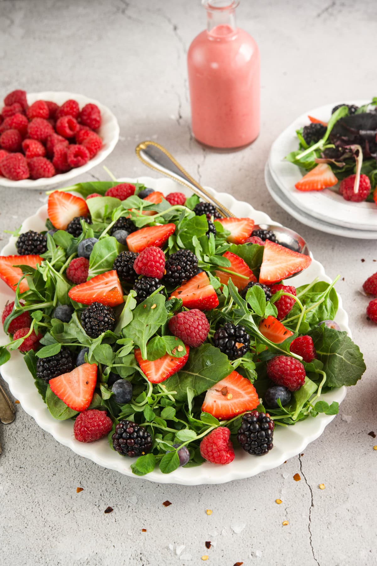 A salad with berries, raspberries and spinach