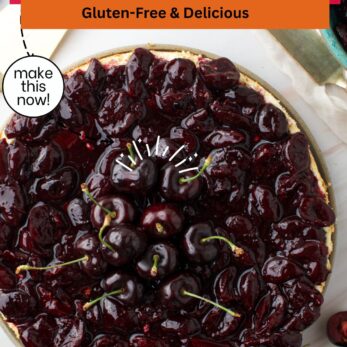 A round cherry cheesecake topped with glossy cherry compote and fresh cherries sits on a marble surface. Text reads Cherry Cheesecake with Cherry Compote - Gluten-Free & Delicious and thetastesoflife.com.