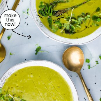 Two bowls of green soup garnished with asparagus, microgreens, and herbs sit on a white surface with a gold spoon. Text reads Roasted Asparagus, Leek, Cannellini Bean Soup and easy to make, incredible taste.