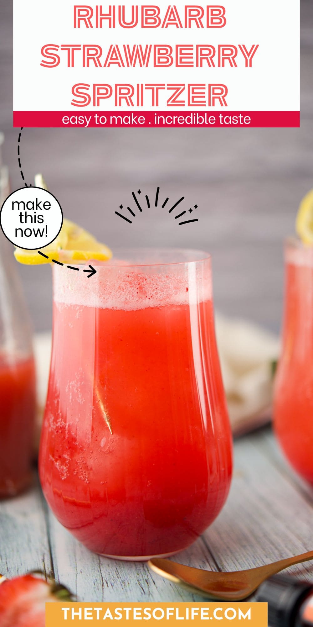 A glass of bright red rhubarb strawberry spritzer garnished with a lemon slice on a wooden table. The text above reads Rhubarb Strawberry Spritzer and below, thetastesoflife.com.