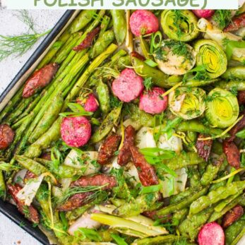 A sheet pan filled with roasted spring vegetables like asparagus, brussels sprouts, radishes, and sliced Polish sausage, garnished with fresh herbs. Text on the image reads: One-sheet pan spring roasted vegetables (with Polish sausage).