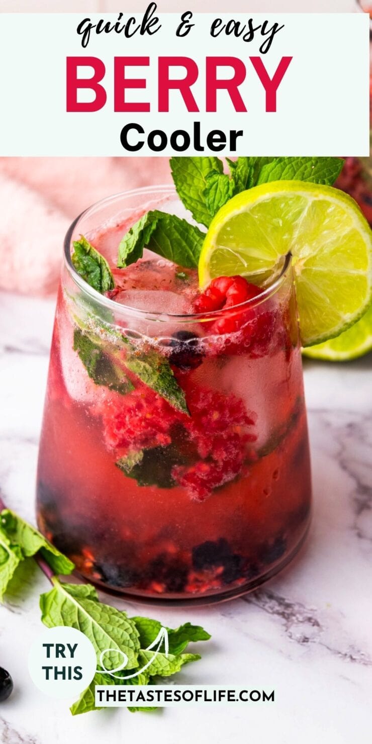 A glass of berry cooler with ice, fresh berries, mint leaves, and a lime slice garnish. Text reads quick & easy BERRY Cooler. Marble surface and more berries and mint are visible in the background.