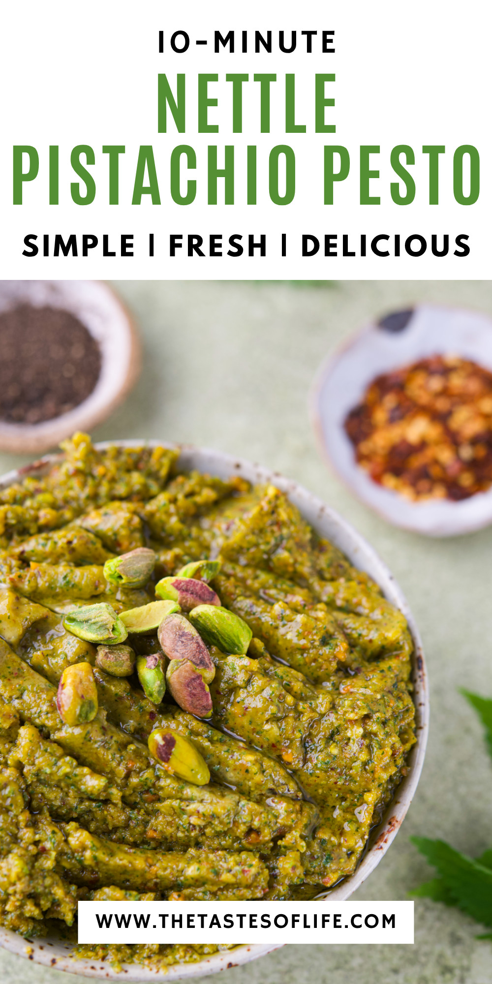 Bowl of green nettle pistachio pesto topped with whole pistachios, next to small dishes of red pepper flakes and black pepper. Text reads “10-Minute Nettle Pistachio Pesto.”.
