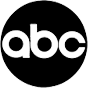 The image shows the lowercase letters abc in white inside a solid black circle. The letters have a glitchy, static-like effect, resembling digital noise or interference.